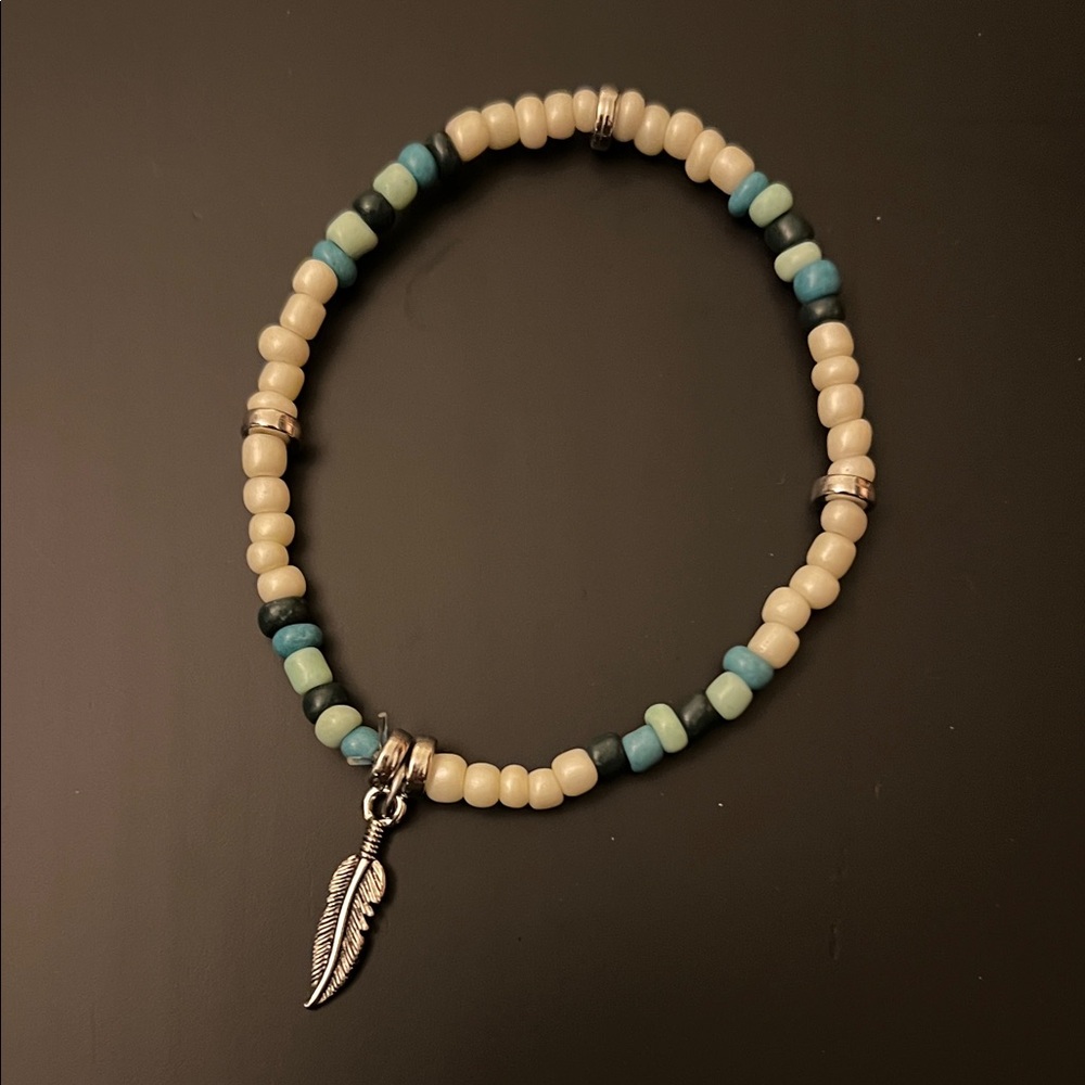 Hand Crafted Cream and Teal Beaded Bracelet with Silver Feather